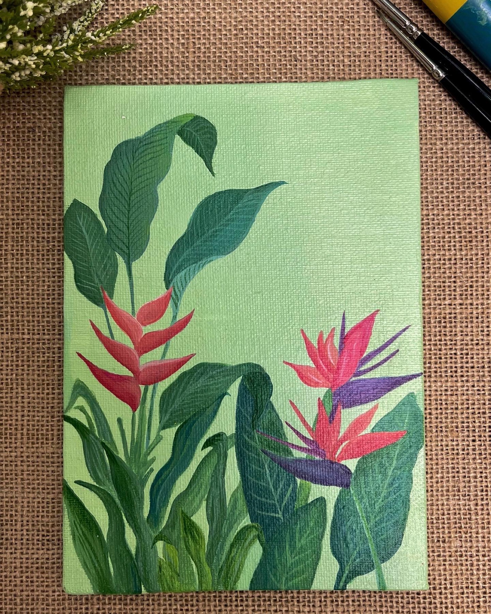 Acrylic painting of red heliconia and bird-of-paradise flowers against a soft green background