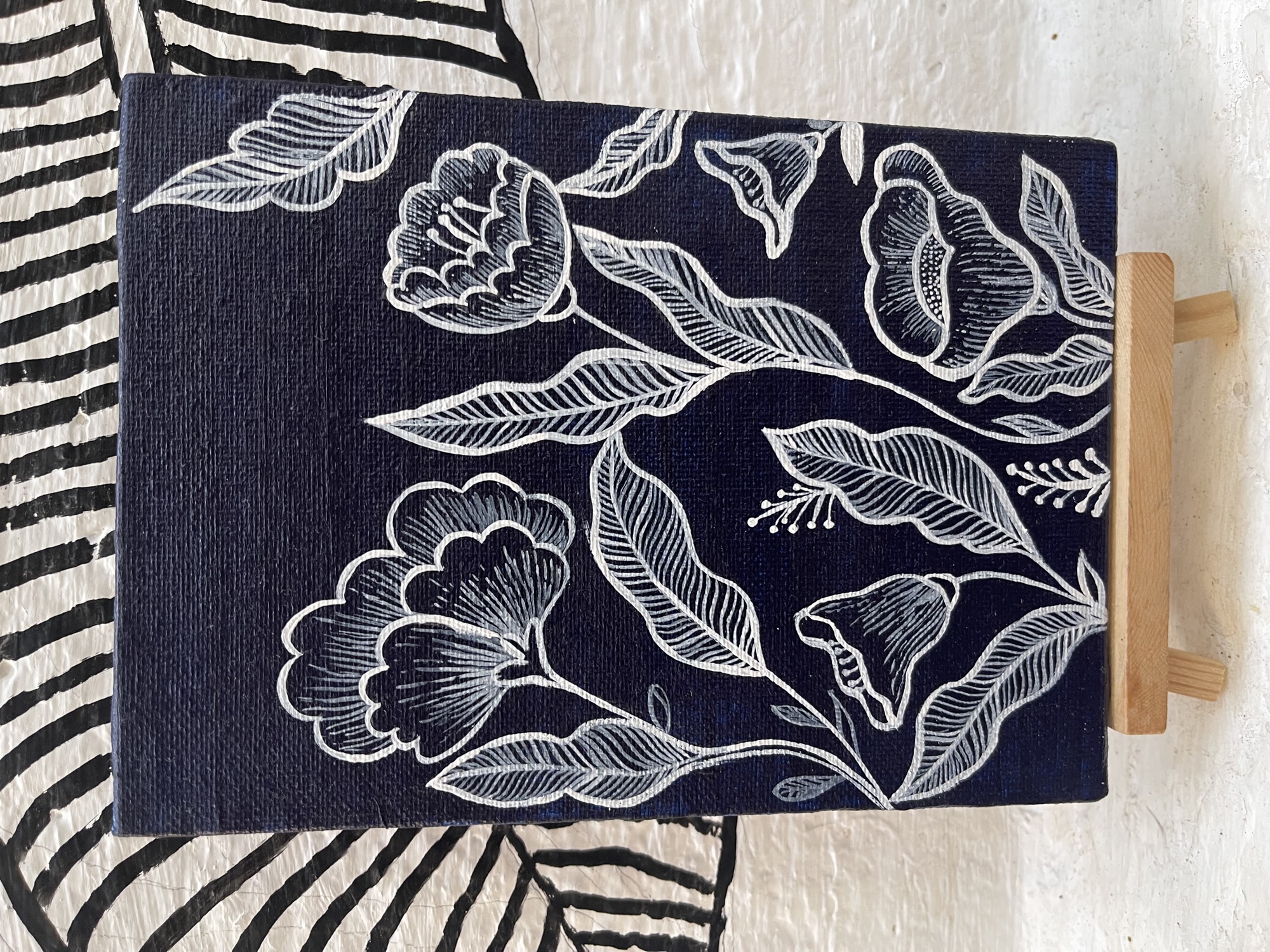 Hand-painted white floral pattern on dark navy fabric, with large blooms and leaves