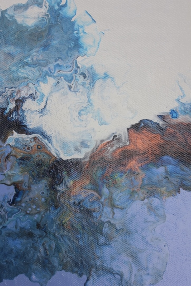 Abstract acrylic pour painting in shades of blue, white and burnt orange with fluid cloud-like formations